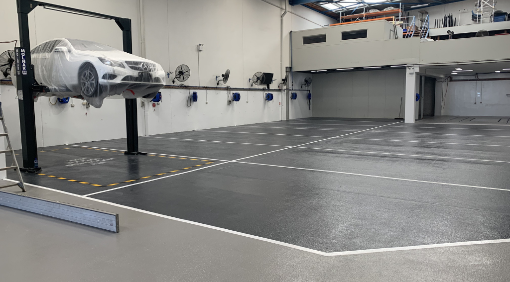 Miranda Auto Body workshop — Mercedes-Benz on hoist, full workshop view