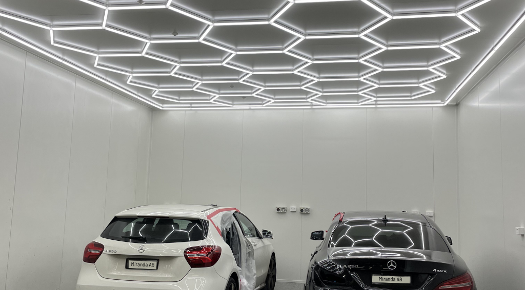 Miranda Auto Body detail bay — hexagonal LED lighting with Mercedes-Benz vehicles